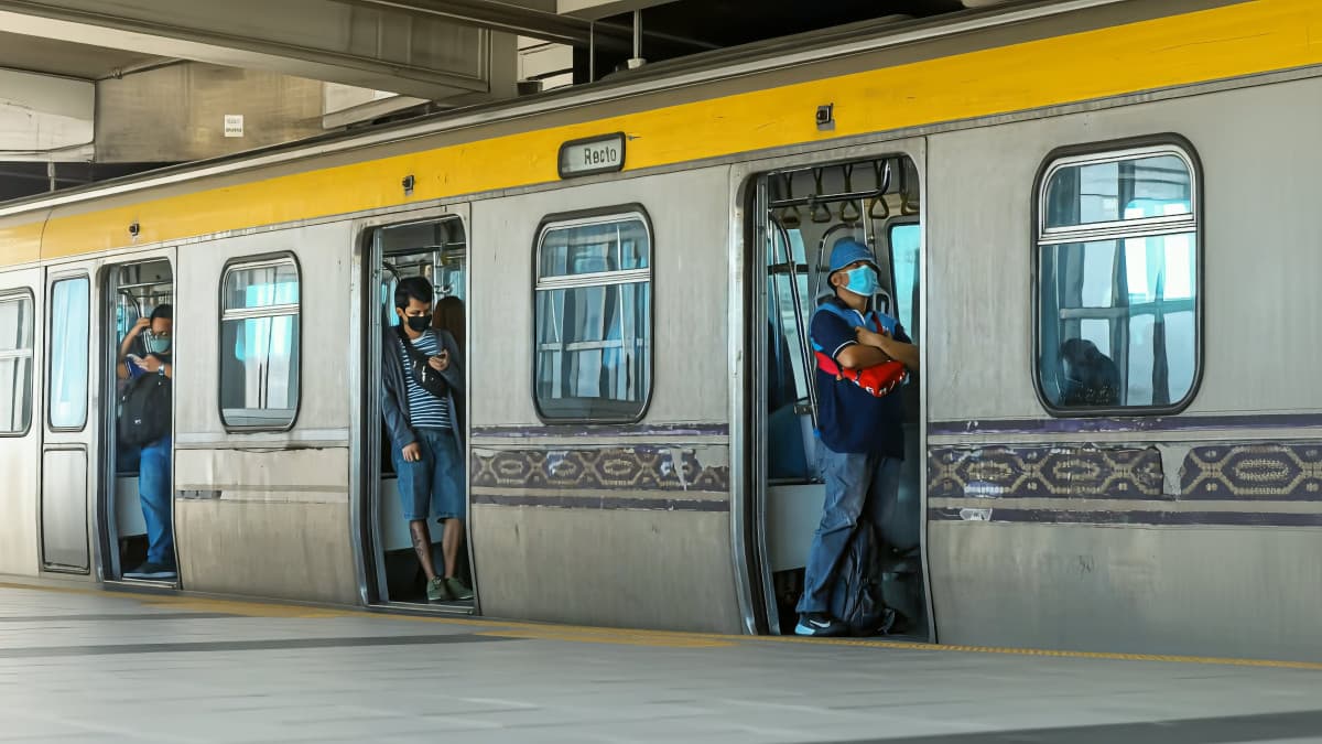 Commuters at an LRT-2 station platform in Metro Manila