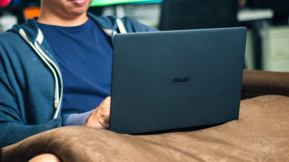 ASUS ExpertBook Ultra laptop open, showing its thin profile and OLED screen